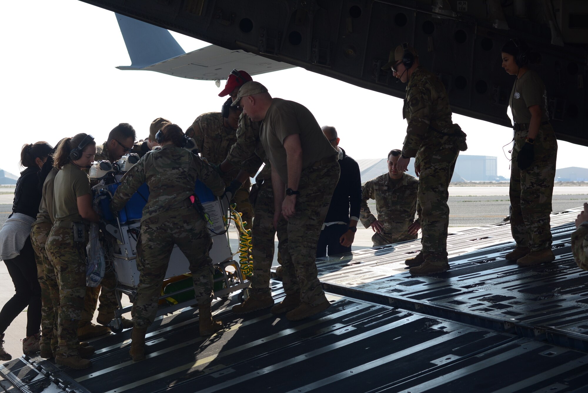 Members of the 156th Airlift Squadron, North Carolina Air National Guard, and Brooke Army Medical Center help a baby suffering a low heart rate and oxygen saturation. The baby was evacuated from Kuwait to Germany on a C-17 Globemaster III aircraft Dec. 25, 2022.