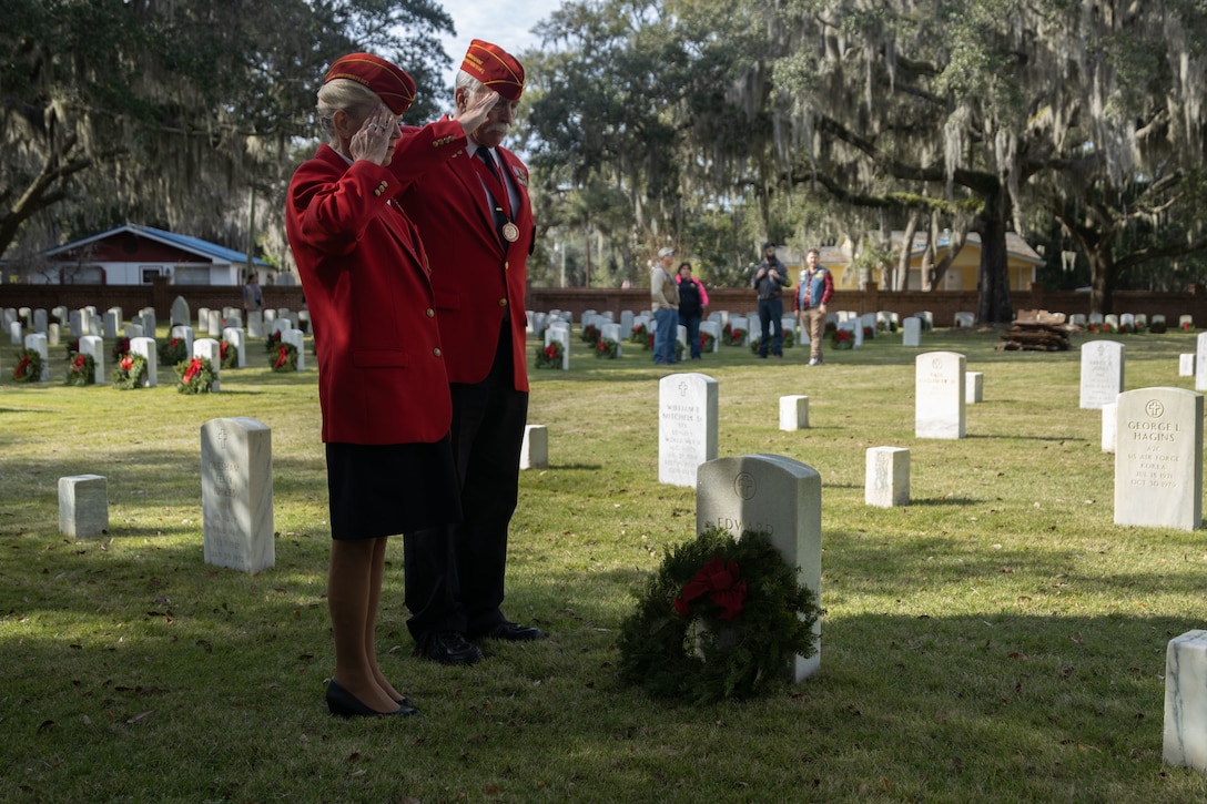 Cathy Stump and John Stump, U.S. Marine Corps veterans, Marine Corps League, Yellow Footprints Detachment, place a wreath during a Wreaths Across America remembrance wreath placing ceremony Dec. 17, 2021. Wreaths Across America honors military members and their families, and remembers those who served. Beaufort National Cemetery is the final resting place for an estimated 26,000 service members, and contains veterans of every conflict between the Civil War and Afghanistan. For the second year in a row a wreath was placed on every grave. (U.S. Marine Corps photo by Sgt. Cheyeanne Campbell)
