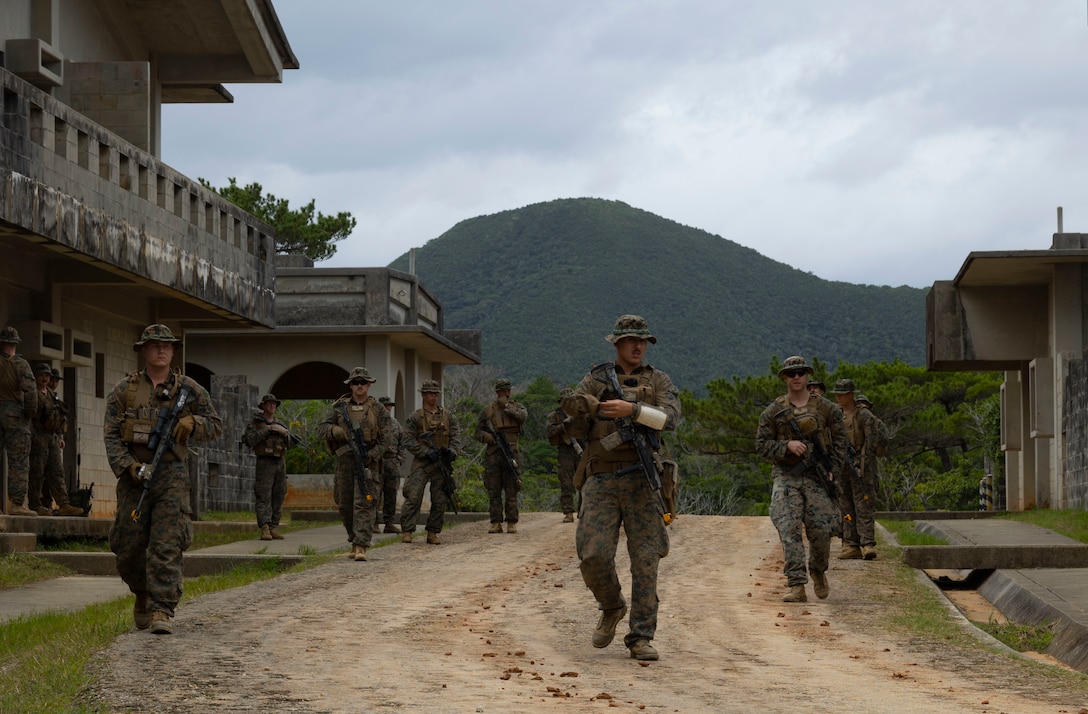 U.S. Marines with 3d Battalion, 4th Marines patrol through an urban training area during Stand-in Force Exercise on Okinawa, Japan, Dec. 6, 2022. SiF-EX is a Division-level exercise involving all elements of the Marine Air-Ground Task Force focused on strengthening multi-domain awareness, maneuver, and fires across a distributed maritime environment. This exercise serves as a rehearsal for rapidly projecting combat power in defense of allies and partners in the region.