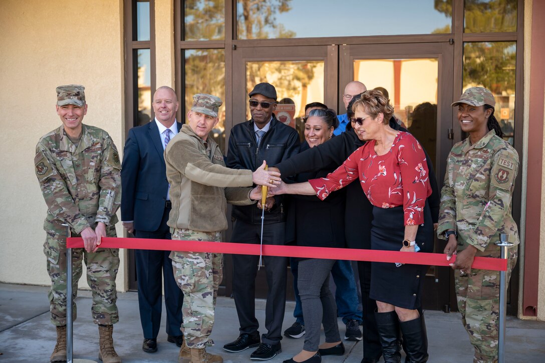 Brig. Gen. Matthew Higer, Commander, 412th Test Wing and Helping Agencies committee members cut the ribbon unveiling the new Helping Agencies facility at Edwards Air Force Base, California, Jan. 6. (Also pictured: Col. Matthew Caspers, Vice Commander, 412th Test Wing and CMSgt. Denisha Ward-Swanigan, Command Chief Master Sergeant, 412th Test Wing)