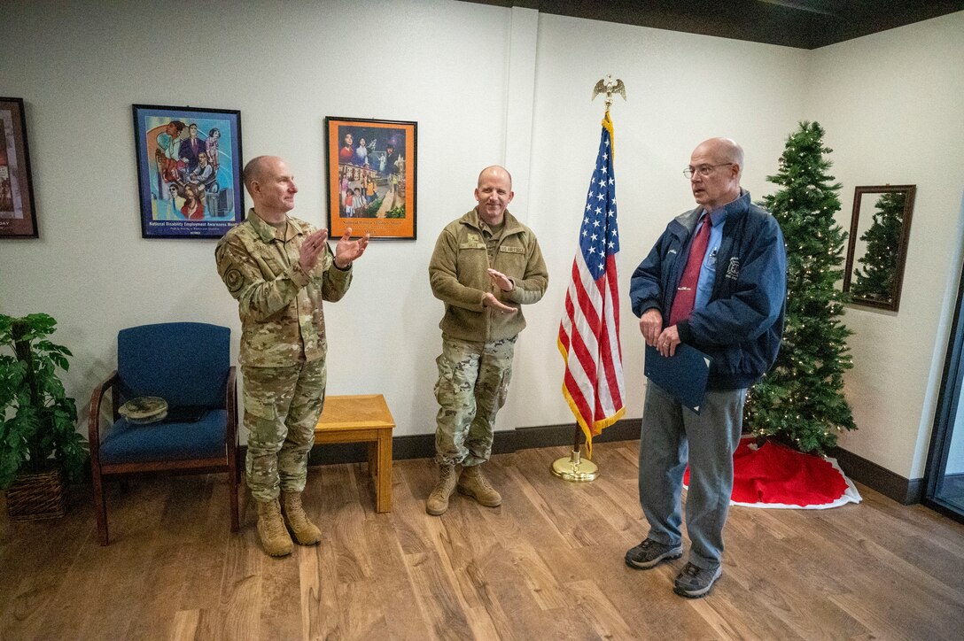 Lt. Gen. Carl E. Schaefer, Deputy Commander, Air Force Material Command and Brig. Gen. Matthew Higer, Commander, 412th Test Wing congratulates Mr. James Judkins, 412th Civil Engineering Group Director after being recognized with the Certificate of Service.