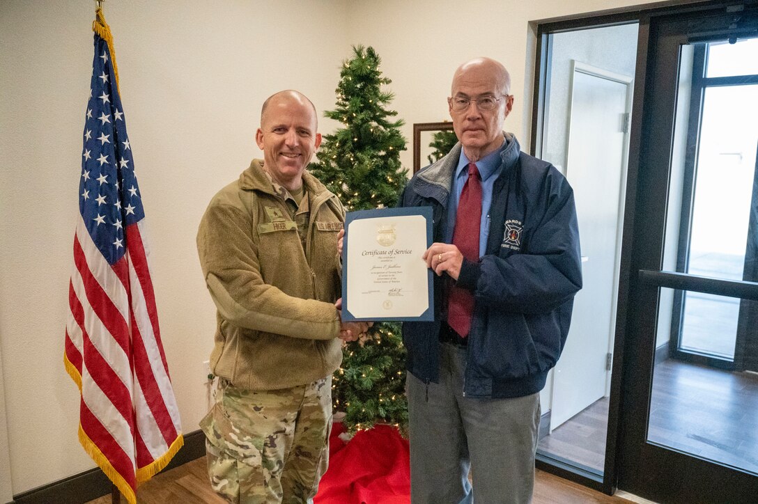 Brig. Gen. Matthew Higer, Commander, 412th Test Wing takes a photo with Mr. James Judkins, 412th Civil Engineering Group Director after being recognized with the Certificate of Service.