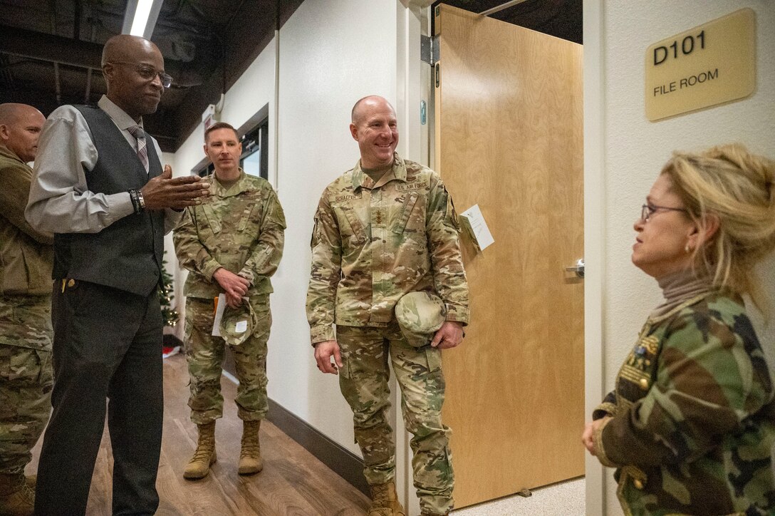 Lt. Gen. Carl E. Schaefer, Deputy Commander, Air Force Material Command and 412th Test Wing leadership tour the new Helping Agencies facility at Edwards Air Force Base, California, Dec. 15. (Also pictured: Ms. Darcy Painter, Community Support Specialist)