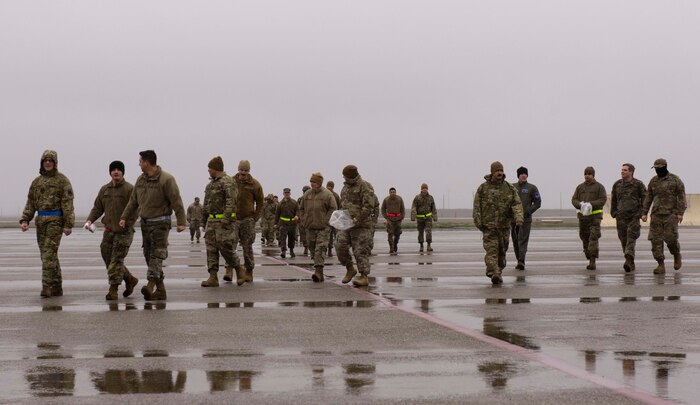 Beale Airmen walk on the flight line conducting a foreign object debris (FOD) walk, Jan. 3, 2022, at Beale Air Force Base, Calif.