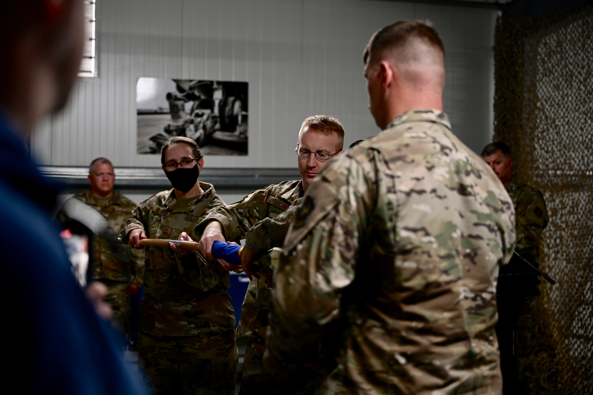 U.S. Air Force Col. Nicholas Delcour, 521st Air Mobility Operations Wing vice commander (left), and members of the 5th Expeditionary Air Mobility Squadron furl the guidon during an inactivation ceremony for the 5th EAMS at Al Mubarak Air Base (Cargo City), Kuwait, June 23, 2022.