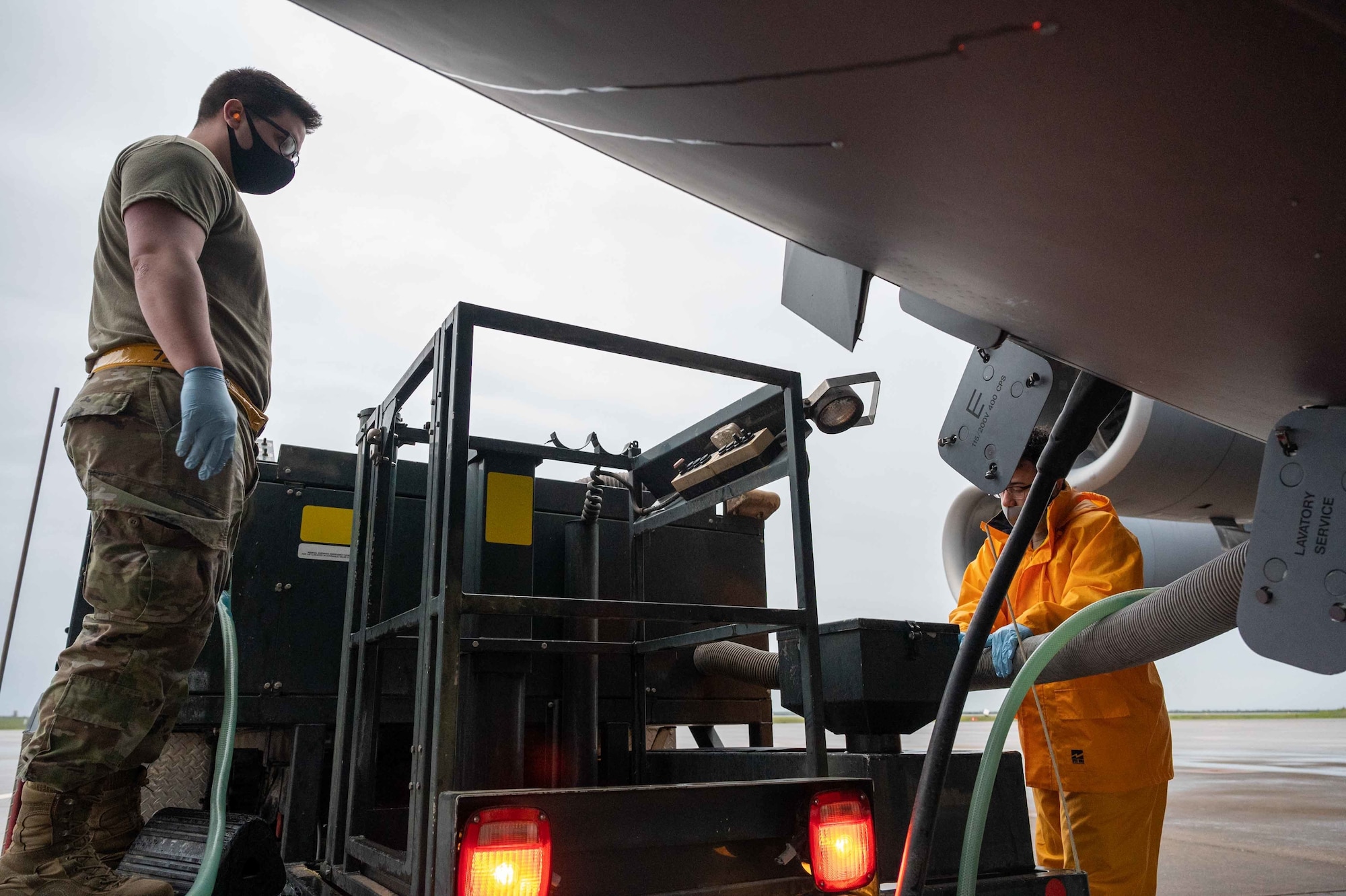 Airman 1st Class Aaron Travers, 728th Air Mobility Squadron aircraft services journeyman, assists Senior Airman Angel Peralta, 496th Air Base Squadron air transportation function specialist, in servicing a C-17 Globemaster III at Morón Air Base, Spain, April 5, 2022.
