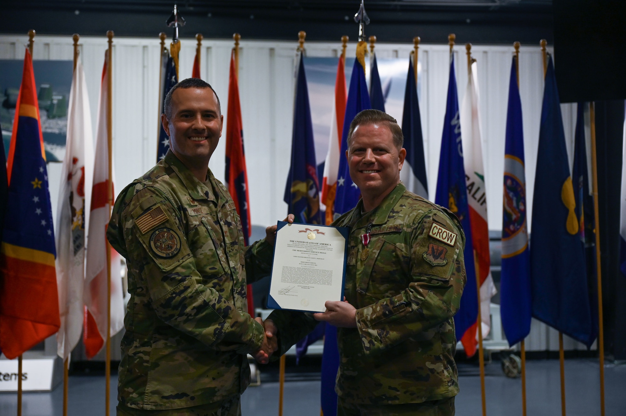 U.S. Air Force Col. John Paul Mintz, 850th Spectrum Warfare Group commander, and Chief Master Sgt. Jason Barnshaw, 850th SWG senior enlisted leader, pose for a photo at Eglin Air Force Base, Fla., Jan. 6, 2023. During Barnshaw’s retirement ceremony he was awarded the Meritorious Service Medal (MSM). The MSM is a military award presented to members of the United States Armed Forces who distinguished themselves by outstanding meritorious achievement or service to the United States (U.S. Air Force photo by Staff Sgt. Ericka A. Woolever)