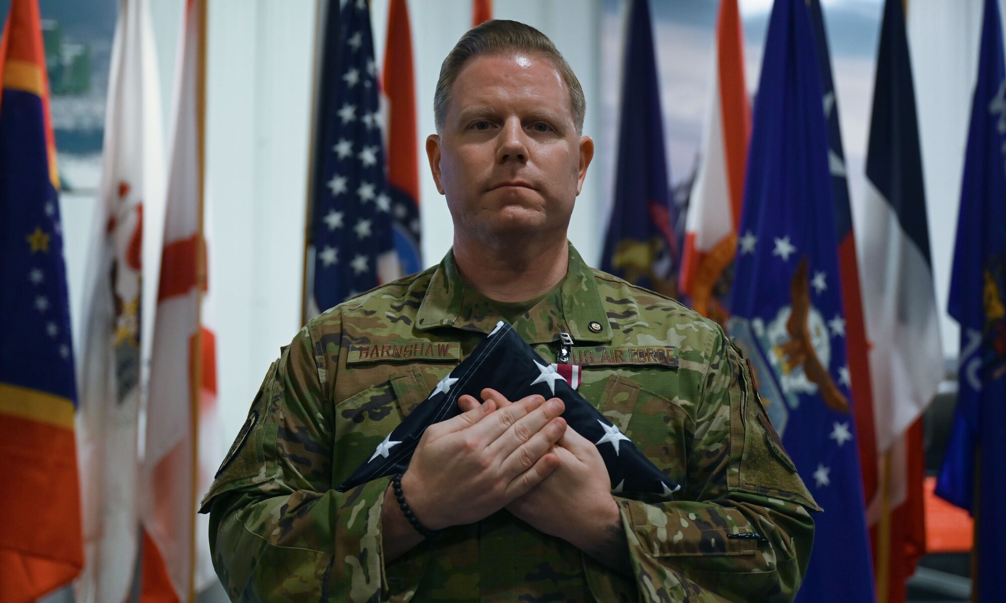 U.S. Air Force Chief Master Sgt. Jason Barnshaw, 850th Spectrum Warfare Group senior enlisted leader, holds a flag at Eglin Air Force Base, Fla., Jan. 6, 2023. Barnshaw has dedicated 25 years of selfless service to the world’s greatest Air Force.  (U.S. Air Force photo by Staff Sgt. Ericka A. Woolever)