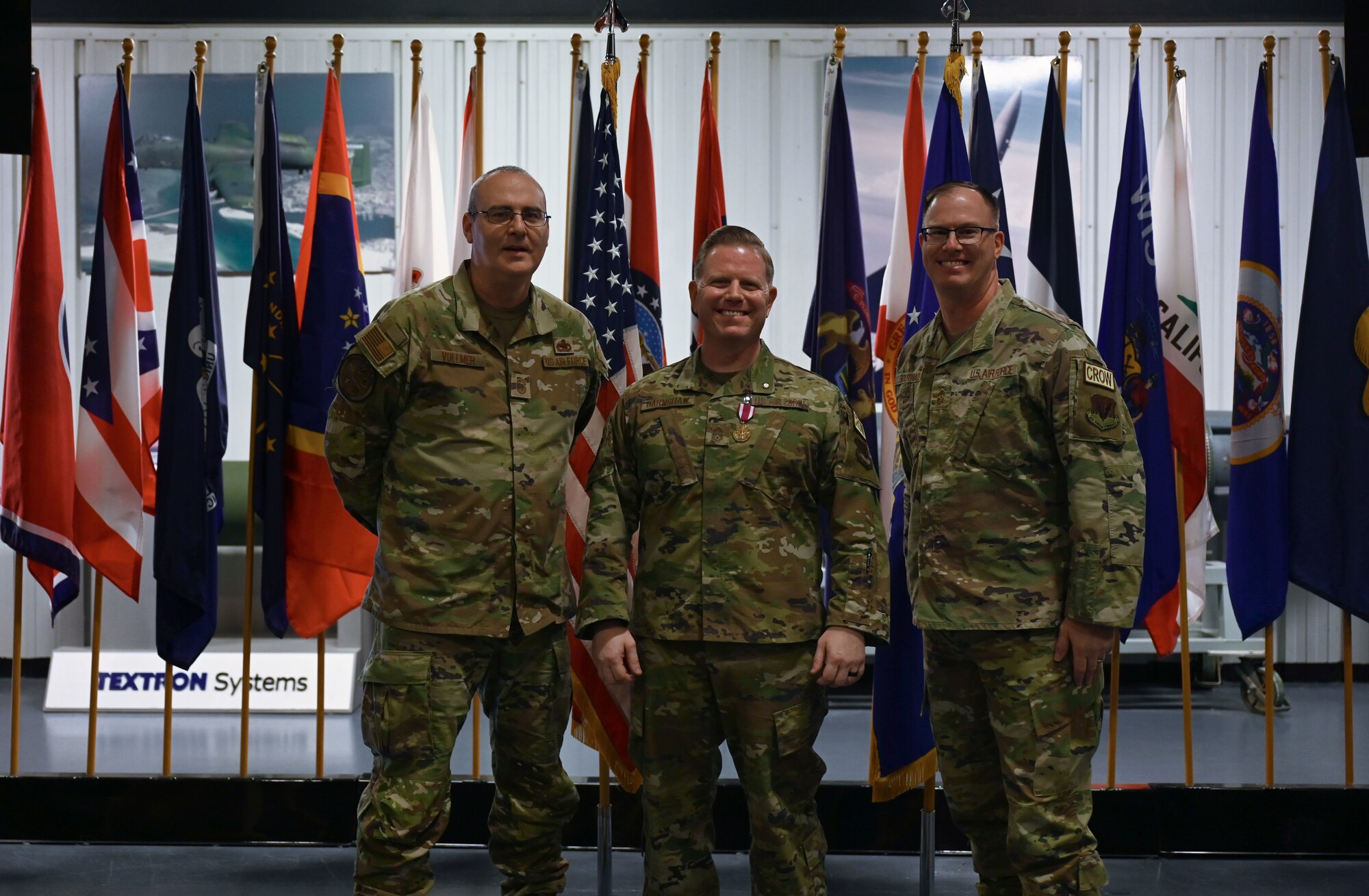 U.S. Air Force Chief Master Sgt. Jason Vollmer, 350th Spectrum Warfare Group senior enlisted leader (SEL), left, Chief Master Sgt. Jason Barnshaw, 850th Spectrum Warfare Group SEL, center, and Chief Master Sgt. David Southall II, 350th Spectrum Warfare Wing command chief, right, pose for a photo during Barnshaw’s retirement at Eglin Air Force Base, Fla., Jan. 6, 2023. Approximately one percent of the enlisted force will be promoted to chief master sergeants, resulting in a great accomplishment. (U.S. Air Force photo by Staff Sgt. Ericka A. Woolever)