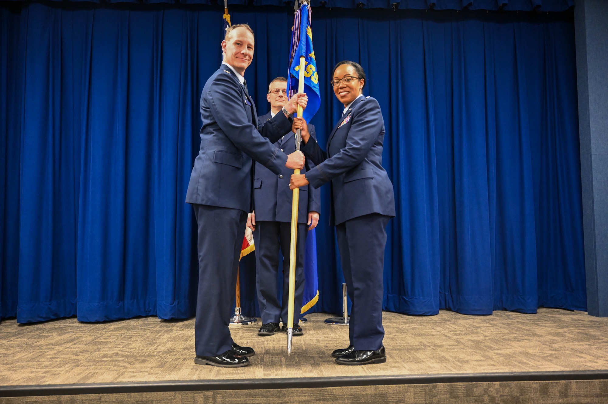 a person passes a flag to another person