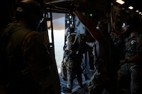 A photo of Airmen preparing to jump from a C-17.