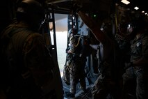 A photo of Airmen preparing to jump from a C-17.