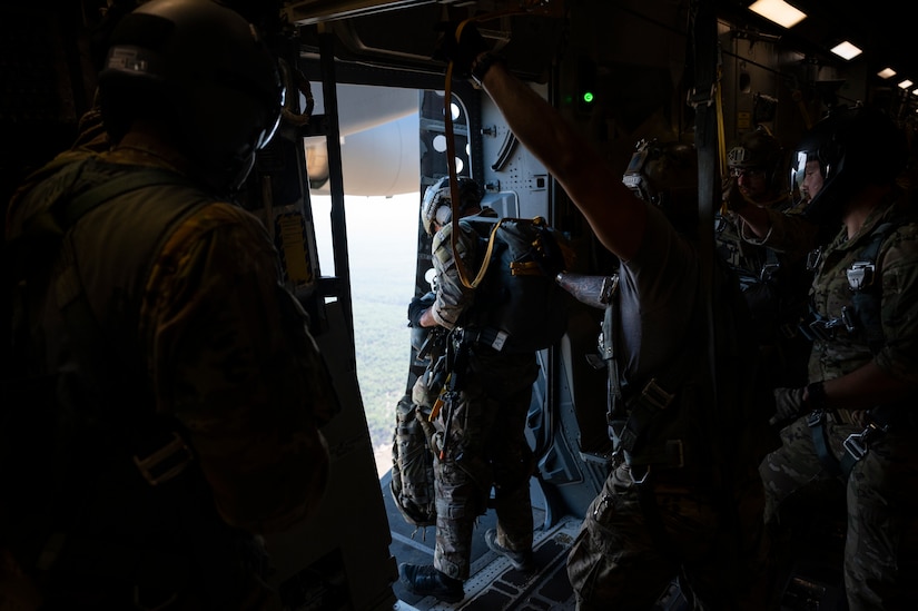 A photo of Airmen preparing to jump from a C-17.