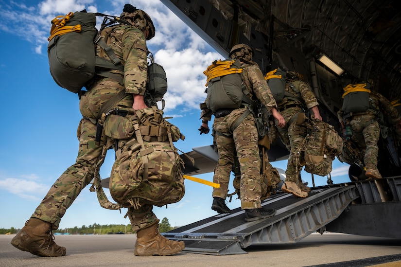 A photo of Airmen loading onto a C-17.