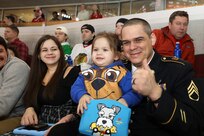 Cara Craggs (left), Amelia (center) and Staff Sgt. Justin Craggs watch the Chicago Blackhawks military appreciation game, January 6, 2023, at the United Center.