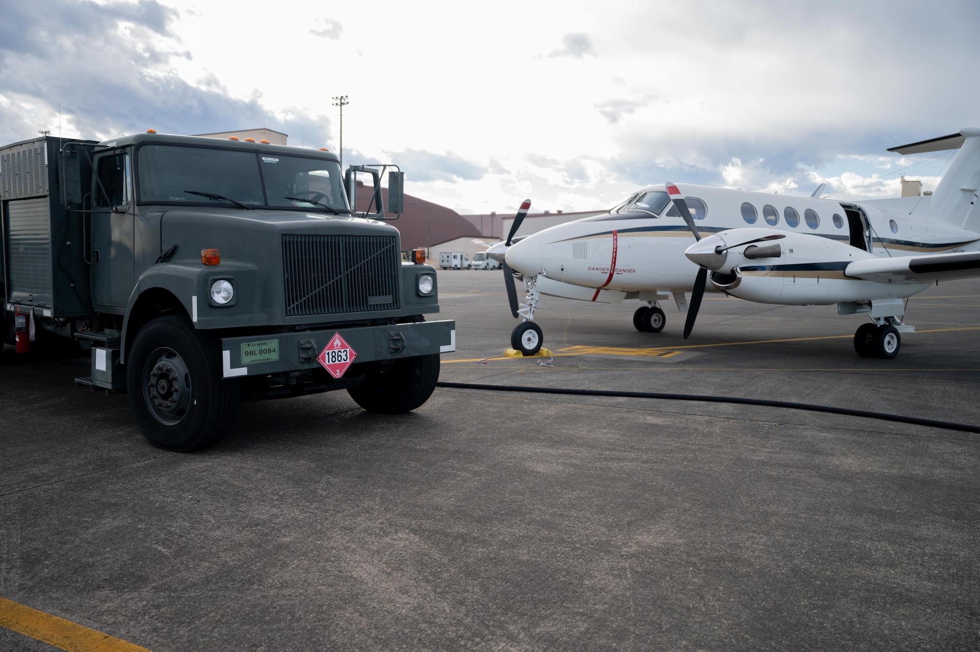 A C-12J Huron from Misawa Air Base and R11 refueling truck sit on the Flightline at Yokota Air Base