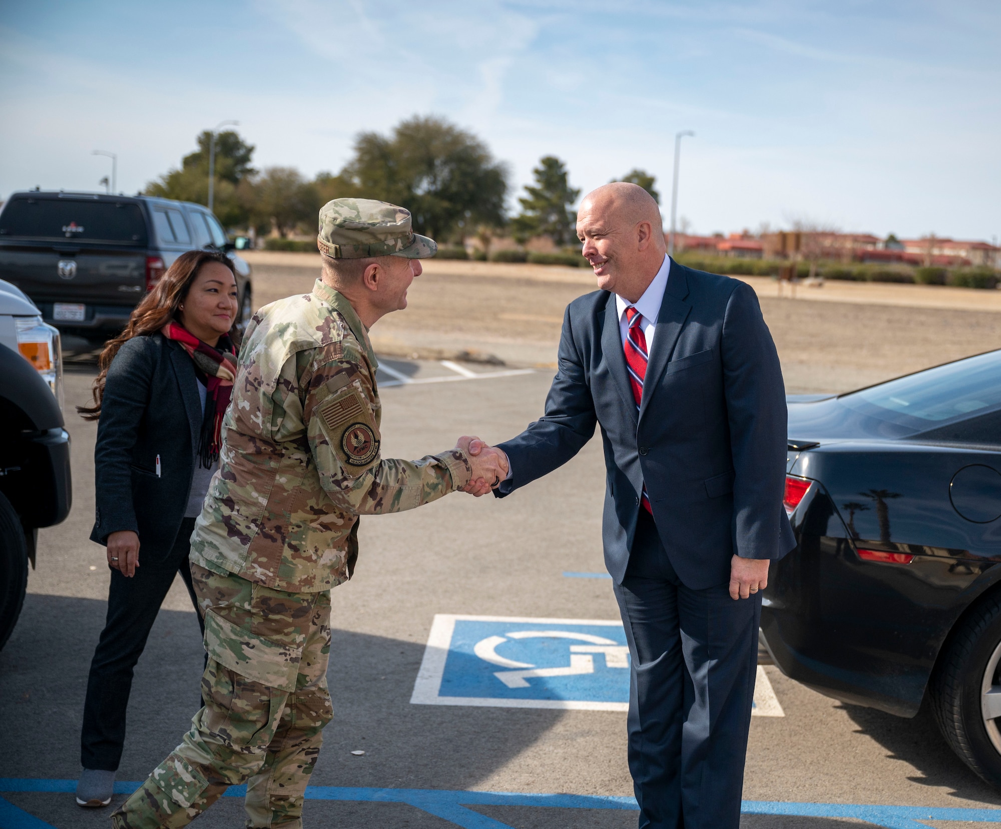 Lt. Gen. Carl E. Schaefer, Deputy Commander, Air Force Material Command shakes hands with Mr. William Brown, Community Support Coordinator while visiting the new Helping Agencies facility at Edwards Air Force Base, California, Dec. 15.