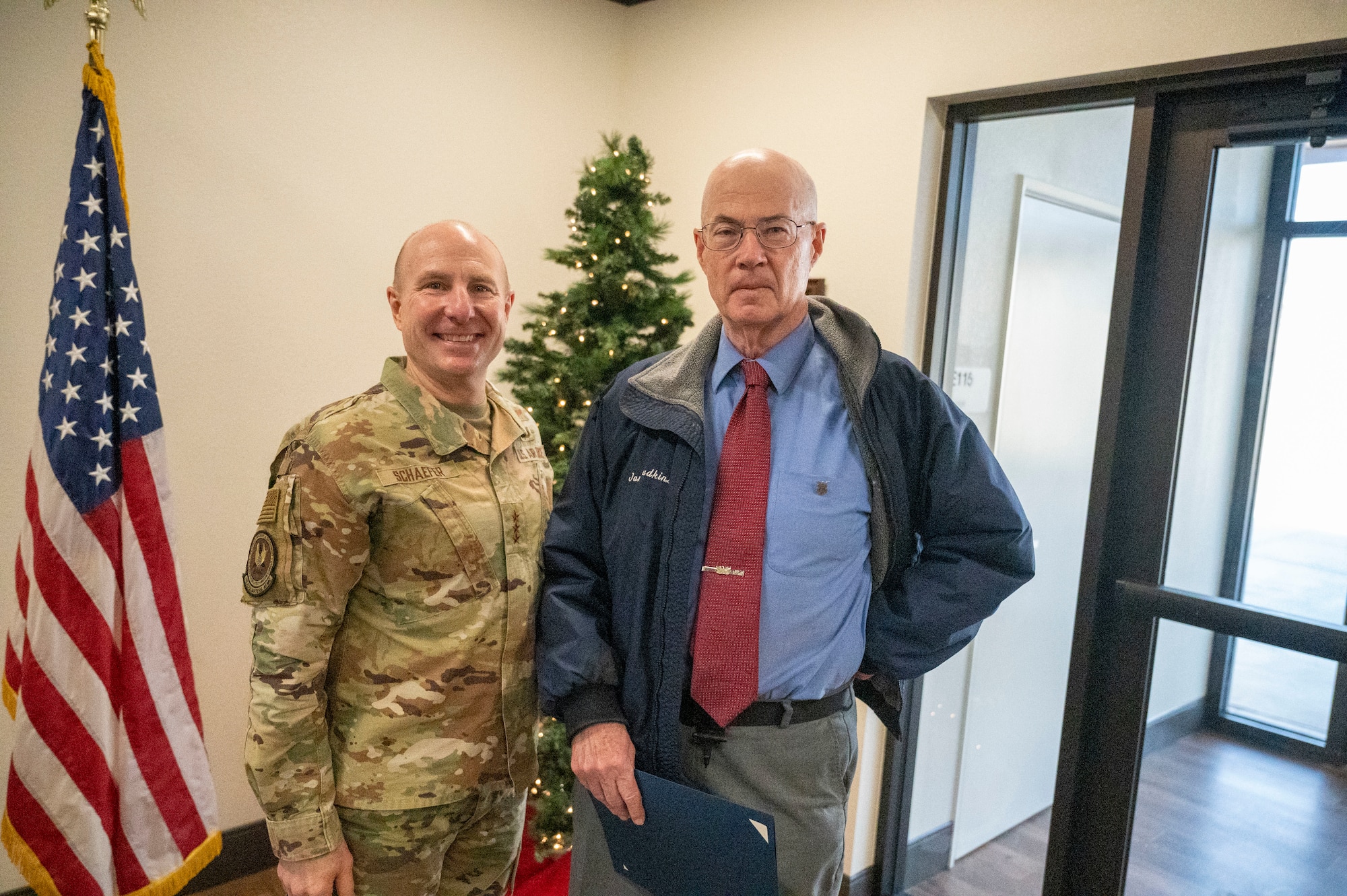 Lt. Gen. Carl E. Schaefer, Deputy Commander, Air Force Material Command takes a photo with Mr. James Judkins, 412th Civil Engineering Group Director after being recognized with the Certificate of Service.