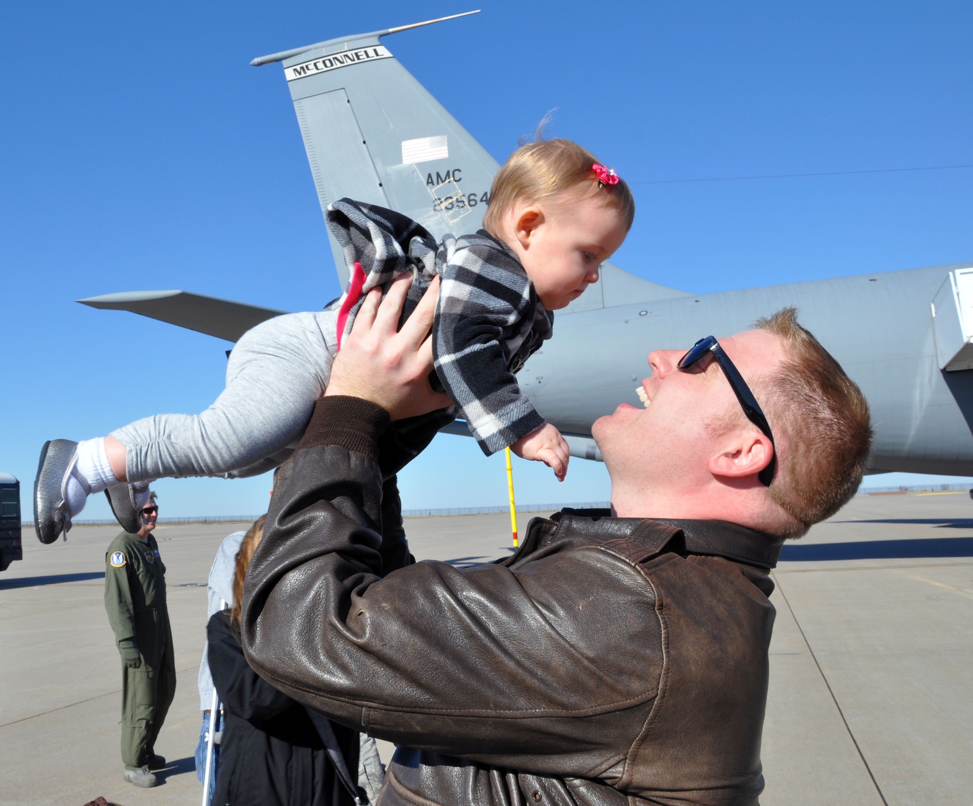 Tech. Sgt. Chris Norris, a refueling boom operator assigned to the 18th Air Refueling Squadron, 931st Air Refueling Group, greets his infant daughter, Bailey, on the flightline at McConnell Air Force Base, Kan., Nov. 12, 2012. Norris had just returned from serving for more than two months deployed as a member of the 90th Expeditionary Air Refueling Squadron at Incirlik Air Base, Turkey. (U.S. Air Force photo by 1st Lt. Zach Anderson)