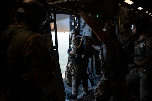 A photo of Airmen preparing to jump from a C-17.