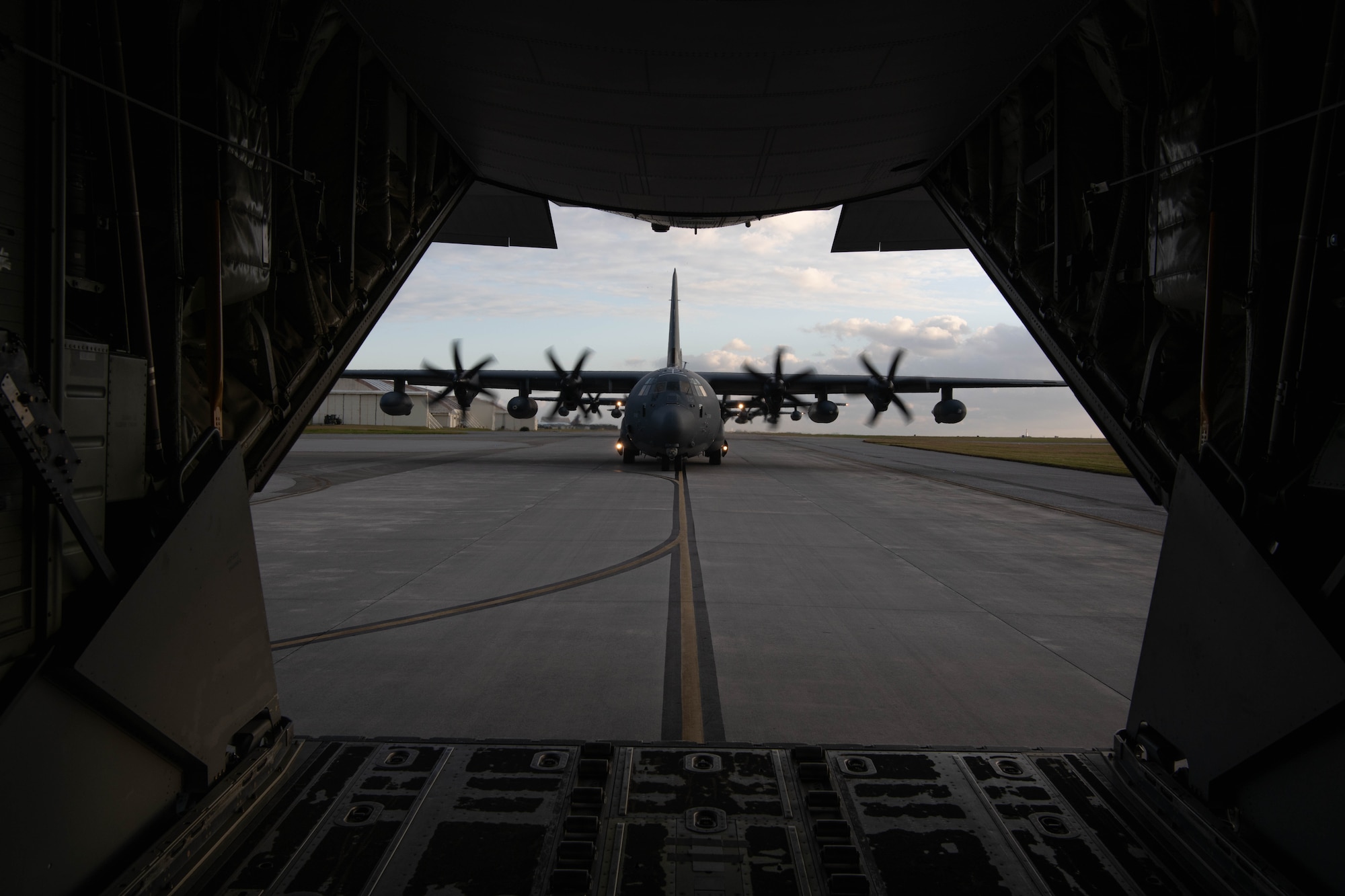 Aircraft taxis behind an MC-130J.