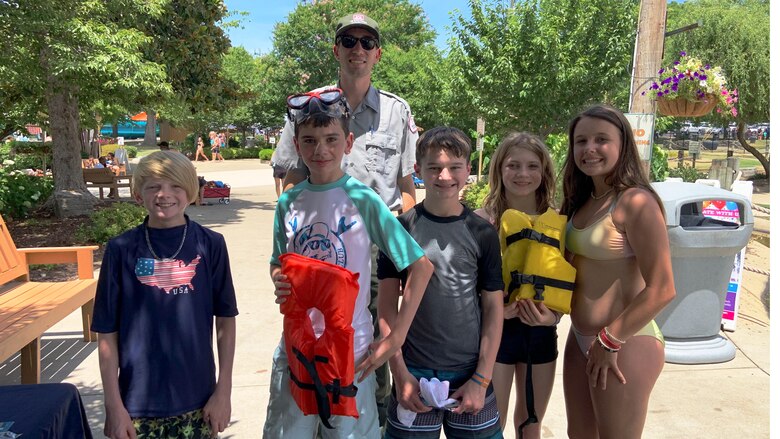 Harrell is seen here posing with local kids after educating them about the importance of water safety, at Nashville Shores