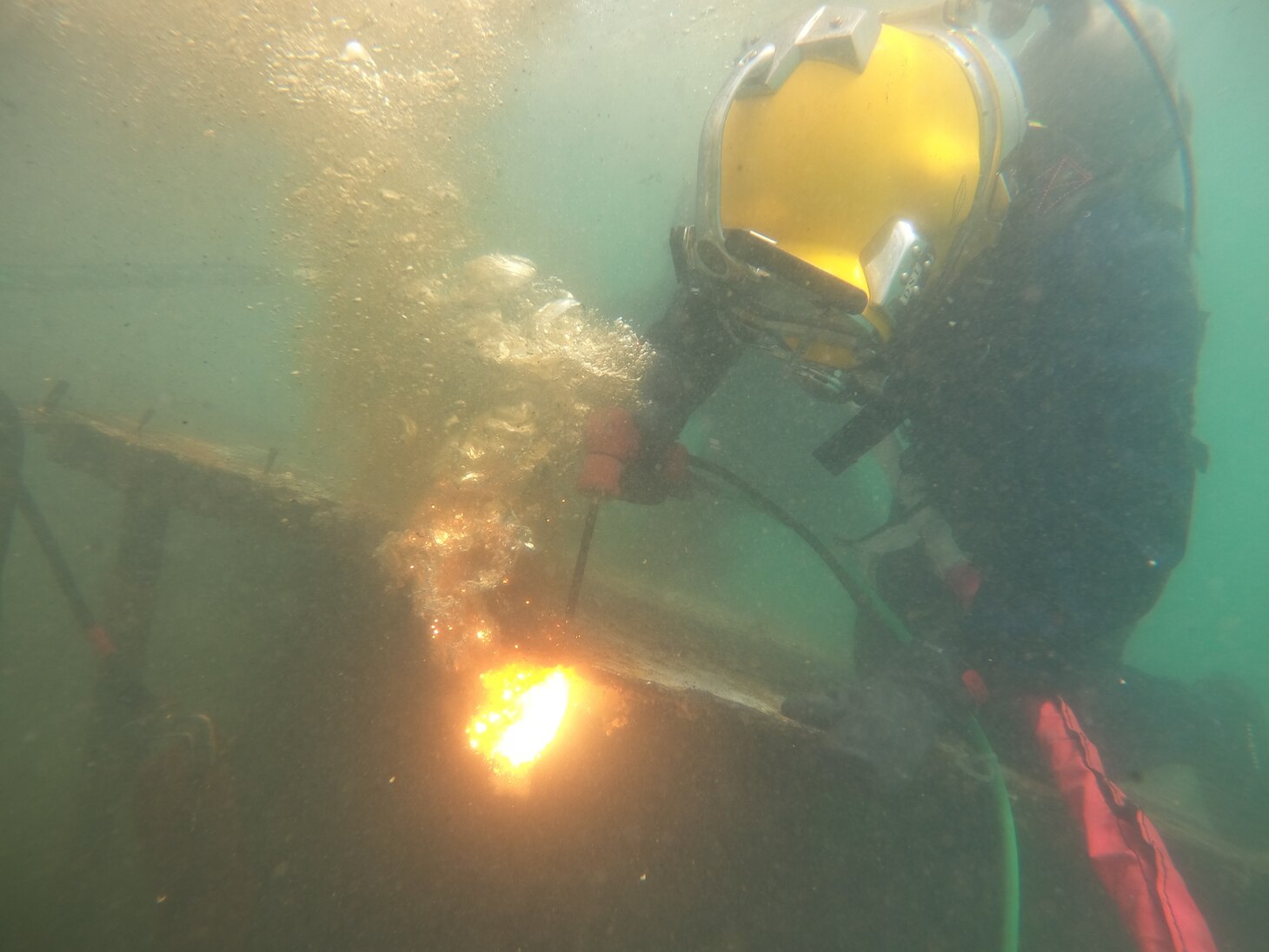 221205-N-NO901-6001 PORT VICTORIA, Seychelles (Dec. 5, 2022) A diver from Underwater Construction Team One cuts apart a shipwreck during a salvage mission in Port Victoria, Seychelles, Dec. 5, 2022. CTF 68, headquartered in Rota, Spain, commands all Navy Expeditionary Forces in U.S. European Command and U.S. Africa Command areas of responsibility and is responsible for providing EOD operations, naval construction, expeditionary security, and theater security efforts in direct support of U.S. Naval Forces Europe-Africa and U.S. Sixth Fleet. (U.S. Navy courtesy photo)