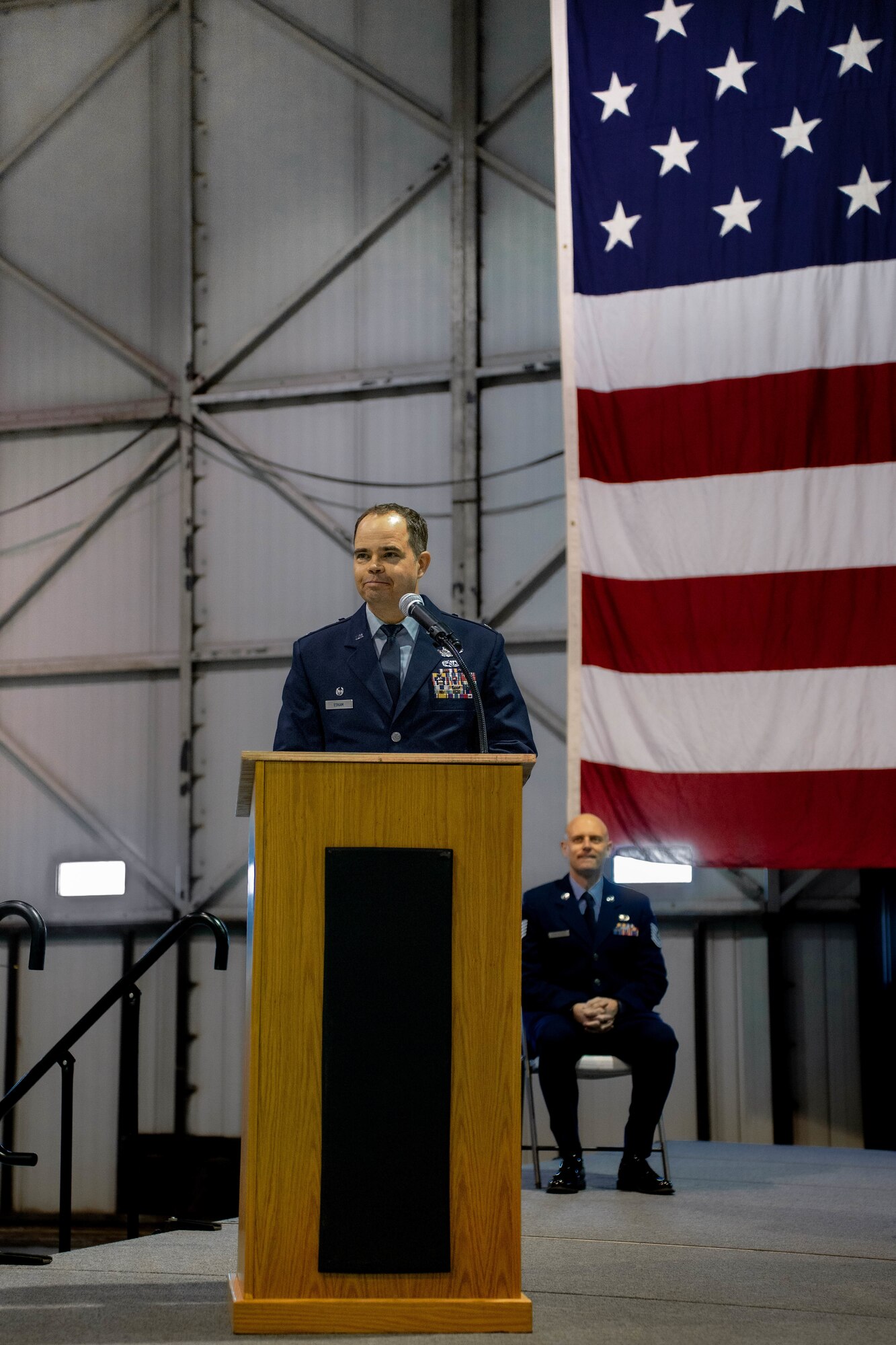 U.S. Air Force Col. Brandon Eskam, 114th Fighter Wing commander, provides remarks after assuming command from Col. Mark Morrell, 114th Fighter Wing outgoing commander (far right), during the 114th FW Change of Command ceremony, Jan. 8, 2023, Joe Foss Field, South Dakota.
