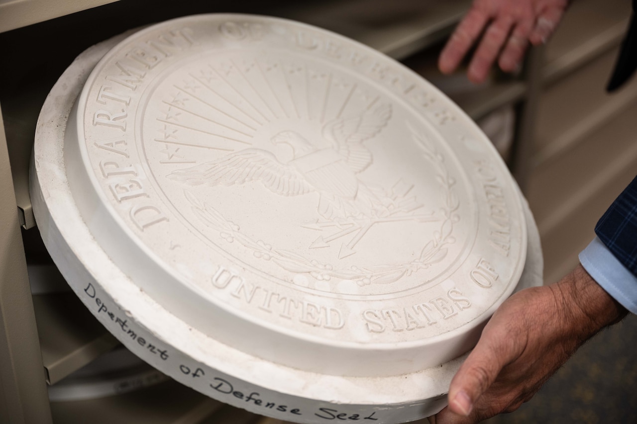 A mold depicts the seal of the Department of Defense.