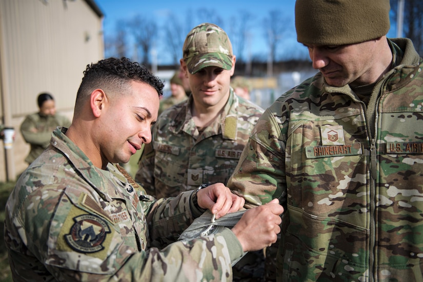 U.S. Air Force Master. Sgt. Kenneth Rivera-Ithier, left, a Deployed Aircraft Ground Response Element member with the 193rd Special Operations Security Forces Squadron, teaches Airmen proper ways to dress wounds, during a Tactical Combat Casualty Care course Jan. 8, 2023, in Middletown, Pennsylvania. Rivera-Ithier, also a TCCC instructor for the Wing, used his military training to assist him in saving the life of a family member over the holidays. (U.S. Air National Guard photo by Tech. Sgt. Tony Harp)