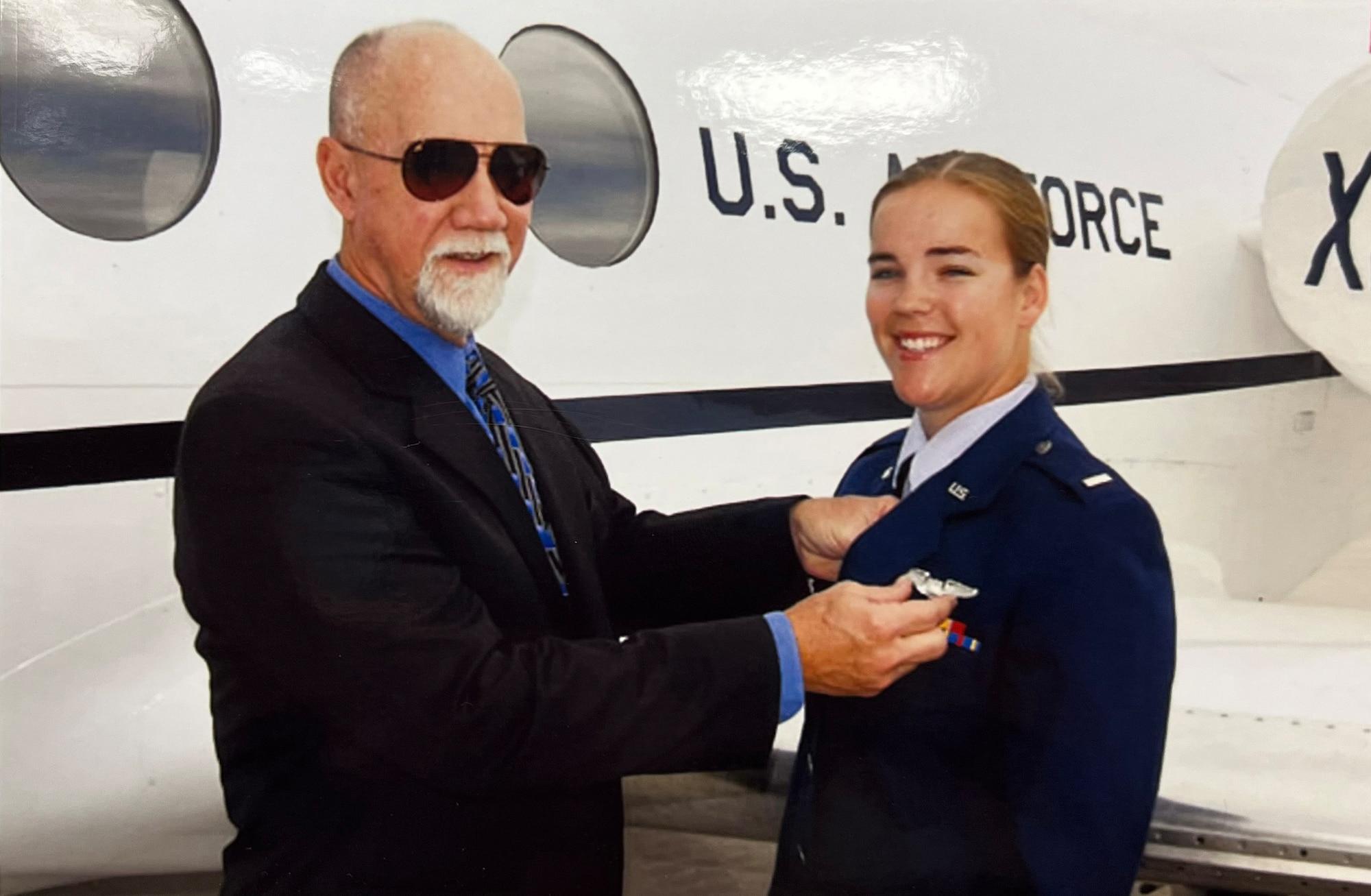 Lt. Col (Retired) Mason Honeycutt pins wings on 1st Lt. Julie Honeycutt.