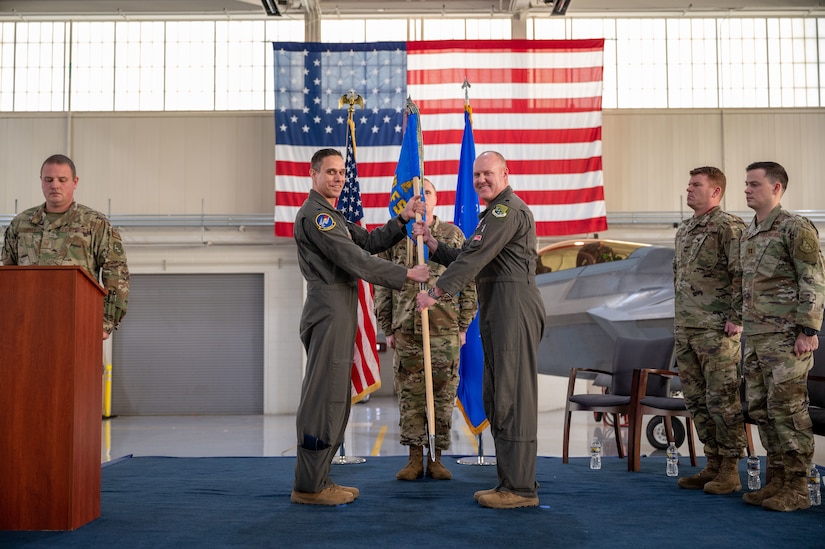 U.S. Air Force Lt. Col. Andrew “Lite” Gray, 94th Fighter Squadron director of operations right, assumes command of the 71st Fighter Squadron from Col. Brandon Tellez, 1st Operations Group commander, at Joint Base Langley-Eustis, Virginia, Jan. 6, 2023.