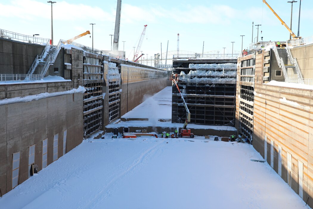 Soo Locks workers chip ice off the downstream miter gate of the Poe Lock in Sault Ste. Marie, Michigan.