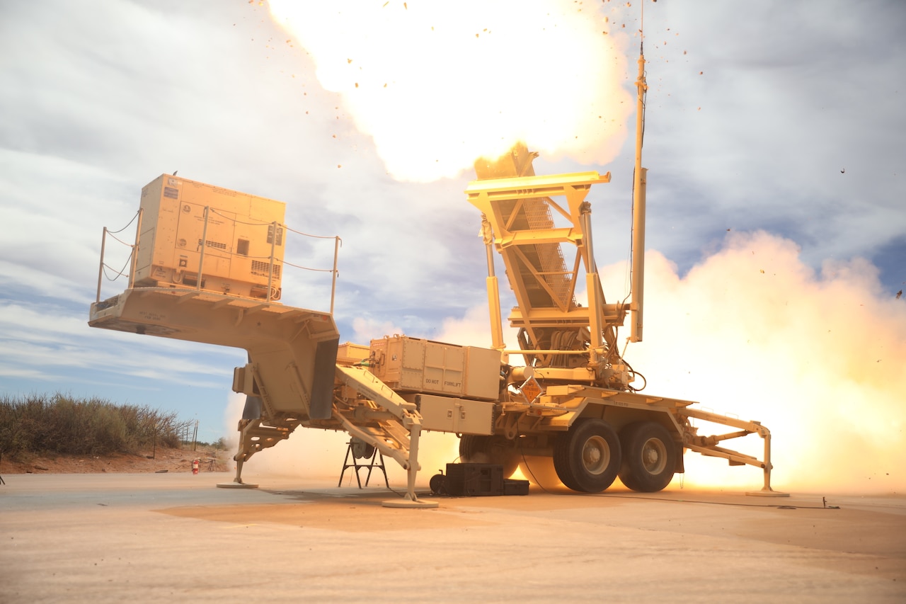 Fire erupts from the launch tubes of a missile launcher.