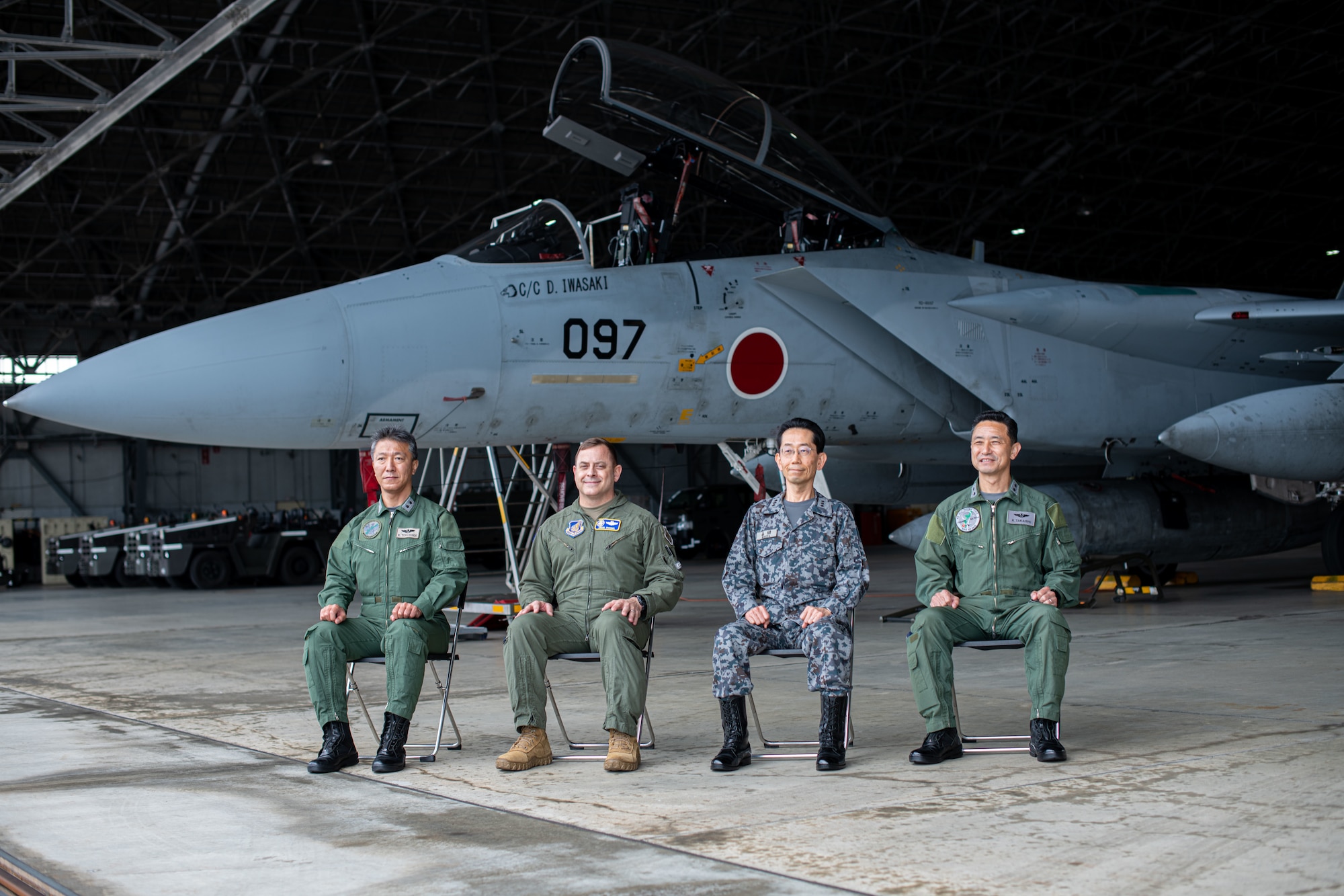 An Airman and Japanese service members pose for a picture.