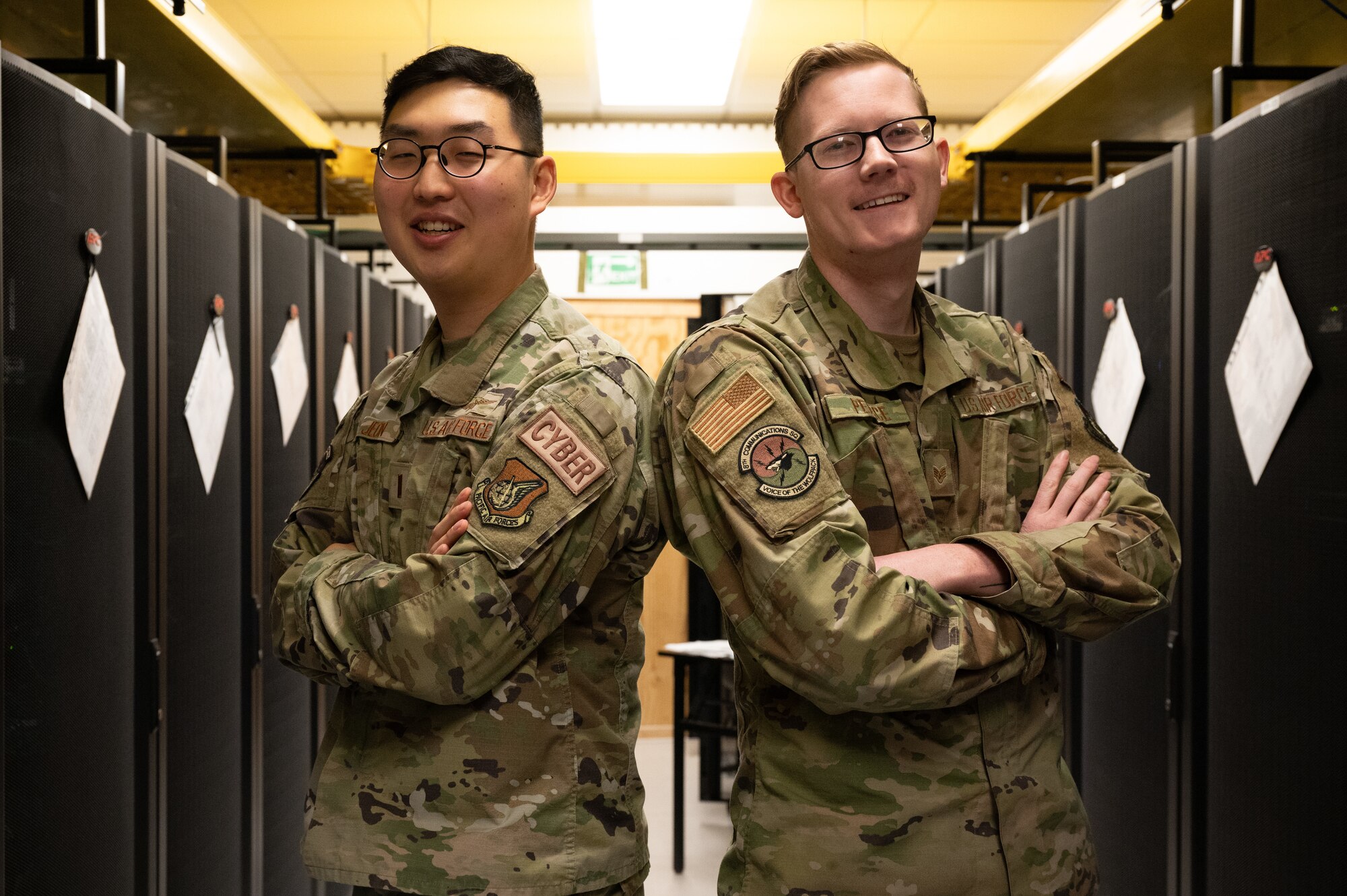 Second Lt. Christopher Jeon (left), 8th Communications Squadron cyber defense officer in charge, and Staff Sgt. Spencer Pearce, 8th CS cyber defense vulnerability NCO in charge, pause for a photo at Kunsan Air Base, Republic of Korea, Jan. 9, 2023. The duo leads a team of cyber defense Airmen who troubleshoot and solve issues with network security to protect Kunsan’s information such as mission planning. (U.S. Air Force photo by Staff Sgt. Sadie Colbert)