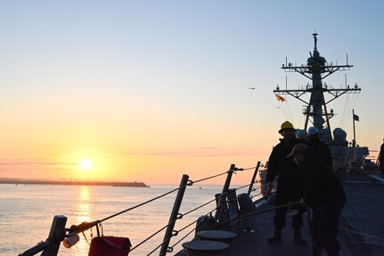 Sailors stand watch as line handlers during an outbound sea and anchor transit aboard the Arleigh Burke-class guided-missile destroyer USS James E. Williams (DDG 95) as the ship departs on a scheduled deployment with Allies and partners as the flagship for Standing NATO Maritime Group Two (SNMG 2).