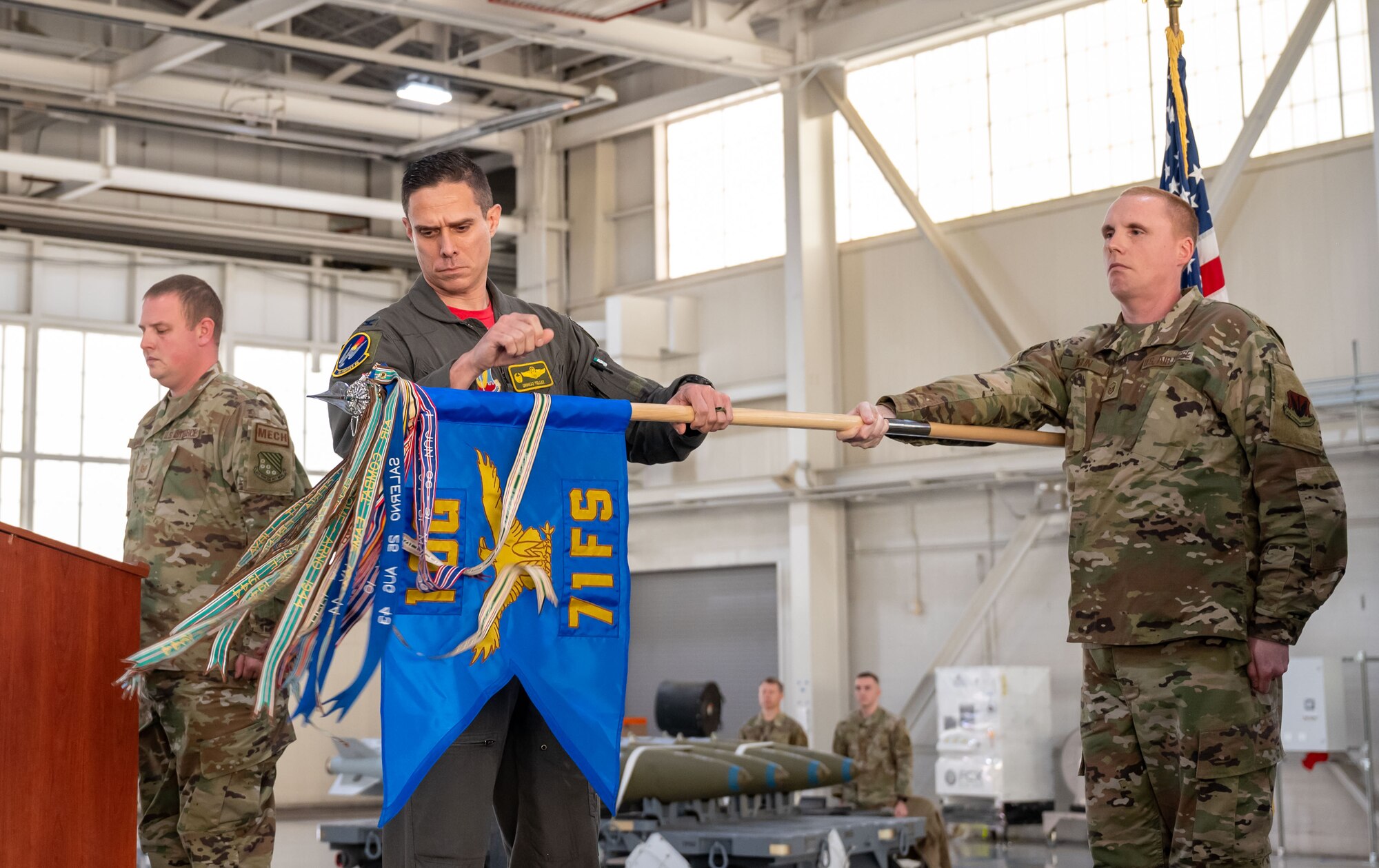 U.S. Air Force Col. Brandon Tellez, 1st Operations Group commander, inspects the 71st Fighter Squadron guide-on during the unit’s reactivation at Joint Base Langley-Eustis, Virginia, Jan 6, 2023.