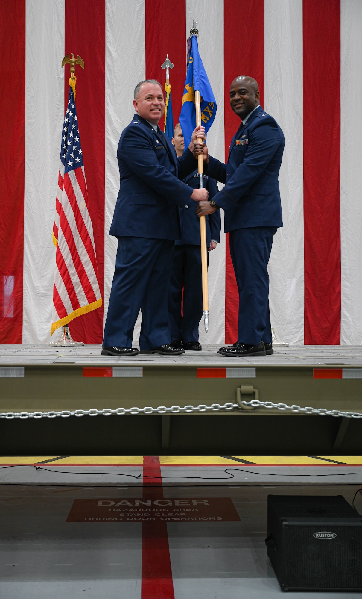 a person hands another person a flag