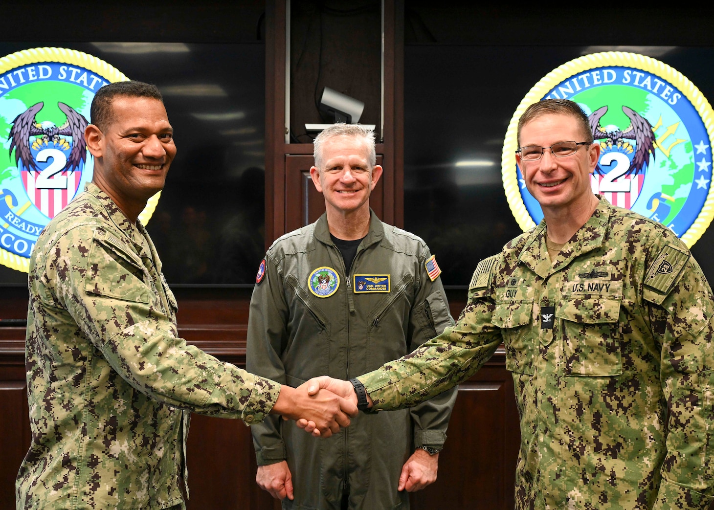 Capt. Blair Guy, right, commodore, Destroyer Squadron 28 (DESRON 28), relieves Capt.  Milciades “Tony” Then, left, commodore, Destroyer Squadron 22 (DESRON 22), as the Maritime Homeland Defense (MHD) DESRON