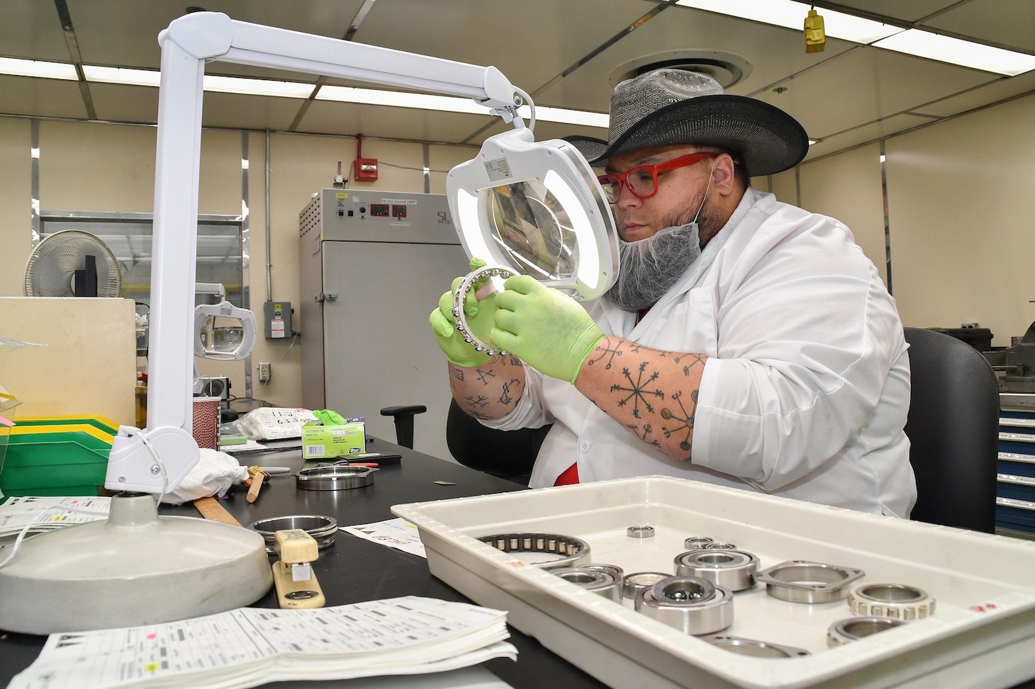 Chad Bogdahn, a bearing reconditioner at Fleet Readiness Center East (FRCE), inspects a bearing inside the depot’s bearing shop.