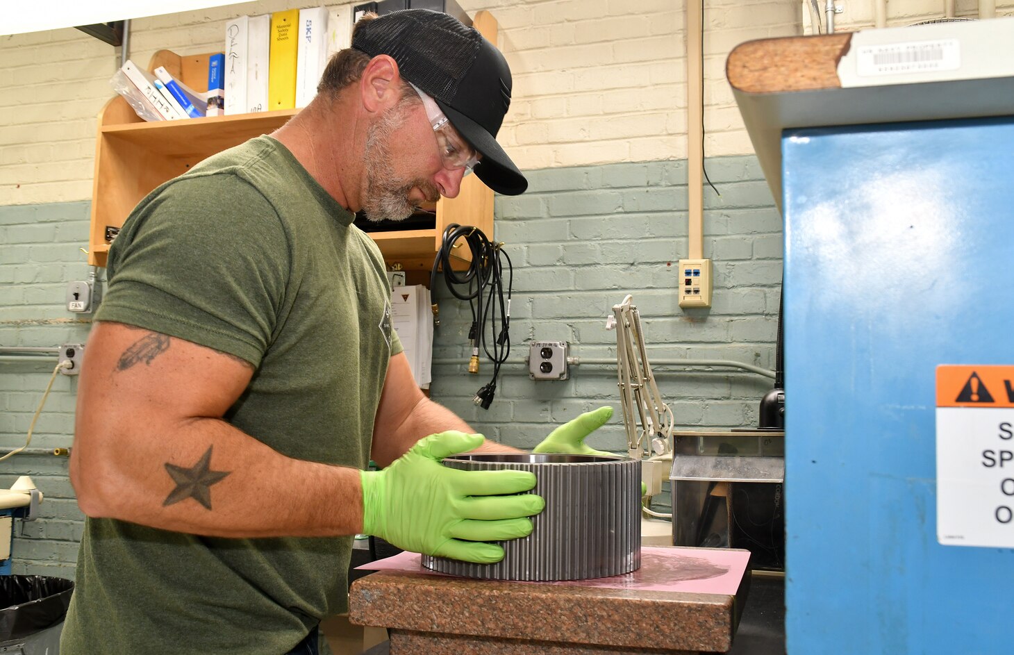 Fleet Readiness Center East (FRCE) Bearing Shop work leader Justin Parrish prepares a bearing for cleaning.