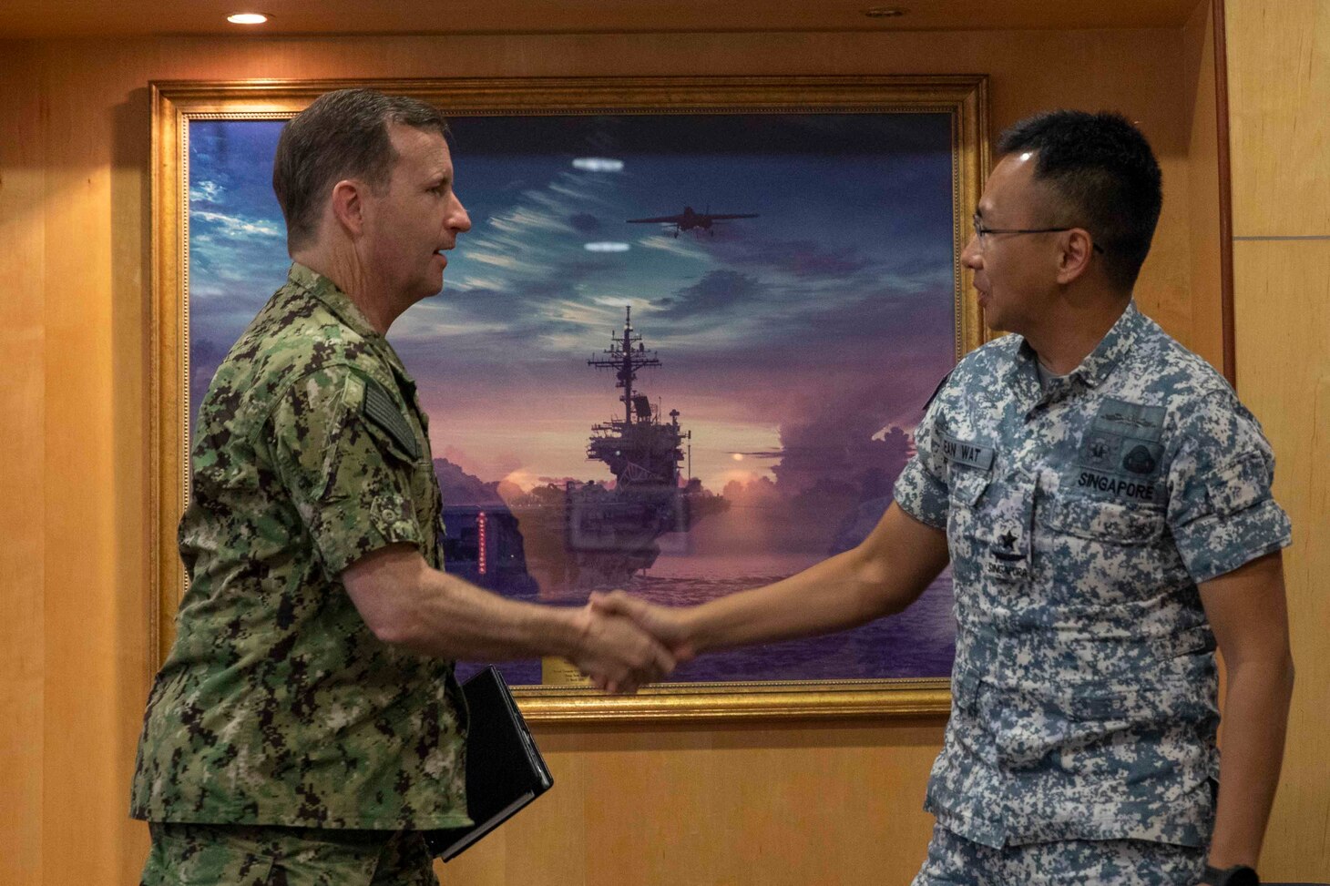 SINGAPORE (Jan. 9, 2023) Rear Adm. Mark Melson, Commander, Logistics Group Western Pacific/Task Force 73, and Rear Adm. Sean Wat, Fleet Commander, Republic of Singapore Navy (RSN), shake hands prior to the opening ceremony of Cooperation Afloat Readiness and Training (CARAT)/Marine Exercise (MAREX) Singapore 2022, Jan. 9, 2023. CARAT Singapore is a bilateral exercise between Singapore and the United States designed to promote regional security cooperation, maintain and strengthen maritime partnerships, and enhance maritime cooperation. In its 28th, the CARAT series is comprised of multinational exercises, designed to enhance U.S. and partner forces’ abilities to operate together in response to traditional and non-traditional maritime security challenges in the Indo-Pacific region. The Makin Island Amphibious Ready Group, comprised of Makin Island, Murtha and amphibious transport dock USS Anchorage (LPD 23), is operating in the U.S. 7th Fleet area of operations with the embarked 13th Marine Expeditionary Unit to enhance interoperability with Allies and partners and serve as a ready-response force to defend peace and maintain stability in the Indo-Pacific region.  (U.S. Navy photo by Mass Communication Specialist 3rd Class Kendra Helmbrecht)