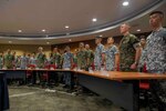 SINGAPORE (Jan. 9, 2023) Commanders and leaders from Logistics Group Western Pacific/Task Force 73, USS Makin Island (LHD 8), Destroyer Squadron 7, Amphibious Squadron SEVEN, USS John P. Murtha (LPD 26), and the Republic of Singapore Navy stand at attention during both countries’ national anthems at the opening ceremony of Cooperation Afloat Readiness and Training (CARAT)/Marine Exercise (MAREX) Singapore 2022, Jan. 9, 2023. CARAT Singapore is a bilateral exercise between Singapore and the United States designed to promote regional security cooperation, maintain and strengthen maritime partnerships, and enhance maritime cooperation. In its 28th, the CARAT series is comprised of multinational exercises, designed to enhance U.S. and partner forces’ abilities to operate together in response to traditional and non-traditional maritime security challenges in the Indo-Pacific region. The Makin Island Amphibious Ready Group, comprised of amphibious assault ship USS Makin Island (LHD 8) and amphibious transport dock USS Anchorage (LPD 23) and USS John P. Murtha (LPD 26), is operating in the U.S. 7th Fleet area of operations with the embarked 13th Marine Expeditionary Unit to enhance interoperability with Allies and partners and serve as a ready-response force to defend peace and maintain stability in the Indo-Pacific region. (U.S. Navy photo by Mass Communication Specialist 3rd Class Kendra Helmbrecht)