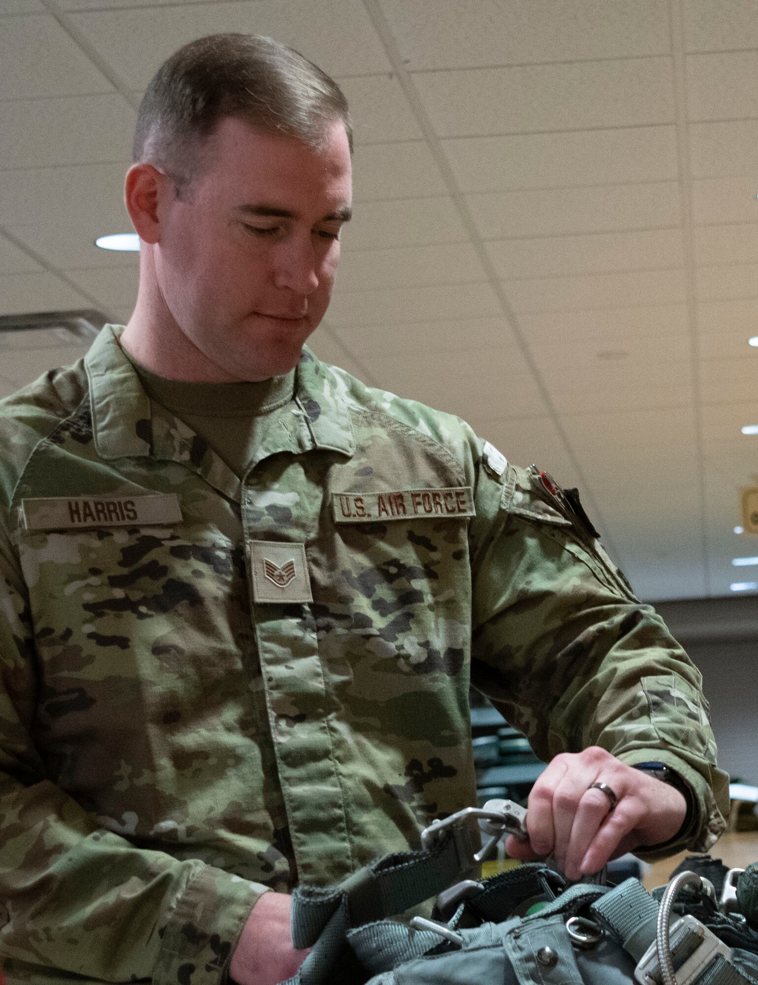 Photo of Airman working on parachute