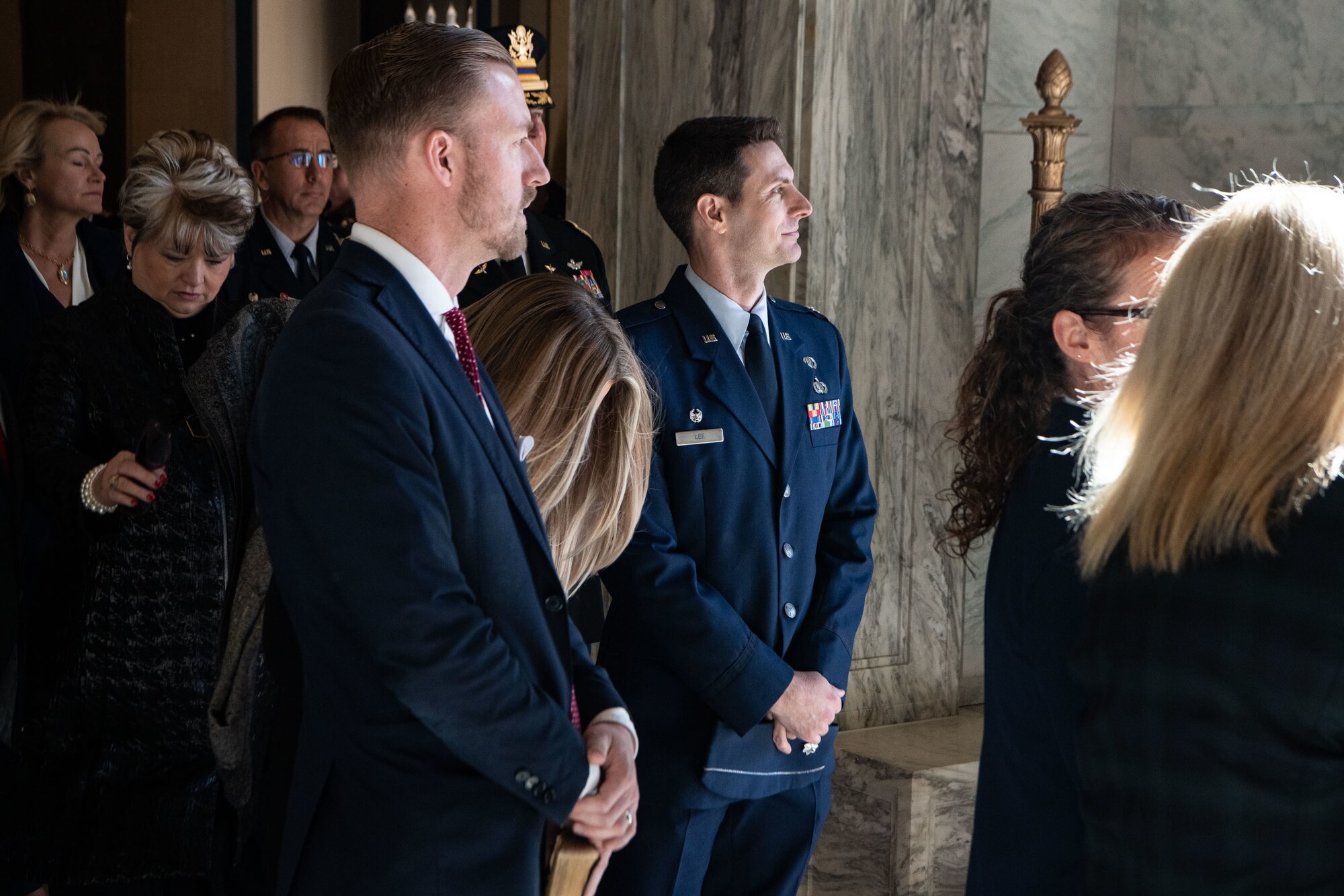 An airman stands alongside people attending the 2023 Oklahoma Governor Inauguration at the Oklahoma State Capitol
