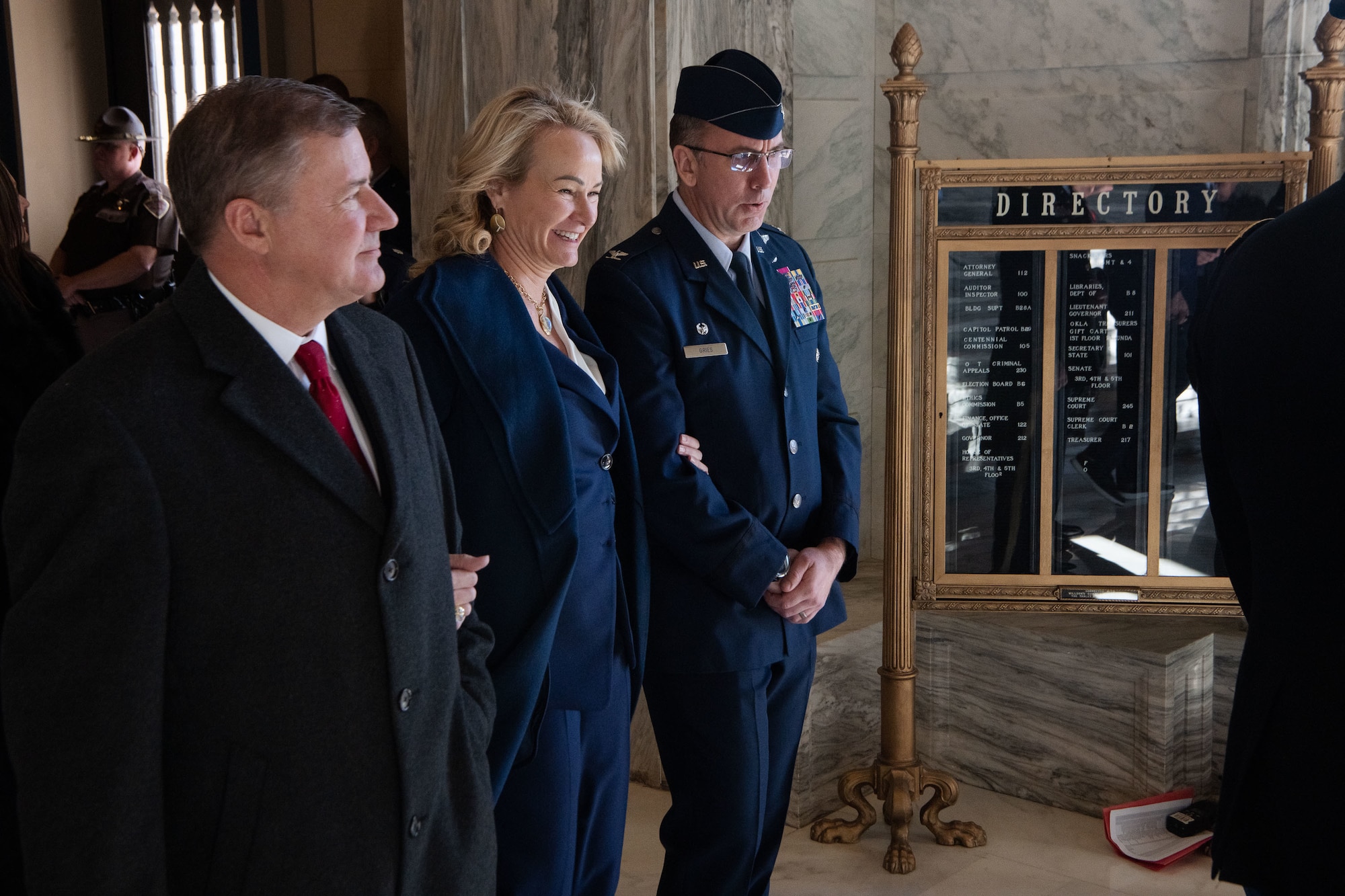an airman stands alongside people attending the 2023 Oklahoma Governor Inauguration at the Oklahoma State Capitol