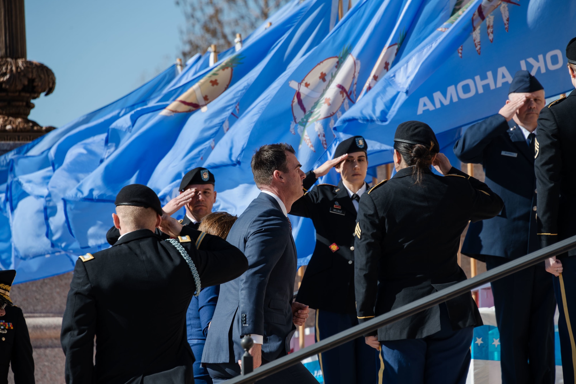 Oklahoma National Guard Soldiers and Airmen lining the stairs of the Oklahoma State Capitol salute Governor Kevin Stitt during the 2023 Oklahoma Governor Inauguration