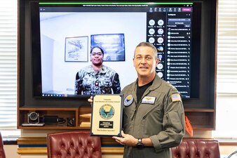 Rear Adm. Pete Garvin, commander, Naval Education and Training Command (NETC), presents Information Systems Technician 2nd Class Sharonda McKenzie, assigned to NETC Site East, with a plaque for her selection as NETC’s 4th Qtr. fiscal year 2022 junior Sailor of the quarter during an awards ceremony in Pensacola, Fla., Jan. 10, 222. NETC’s mission is to recruit, train and deliver those who serve our nation, taking them from street-to-fleet by transforming civilians into highly skilled, operational and combat ready warfighters. (U.S. Navy photo by Mass Communication Specialist 2nd Class Zachary Melvin)