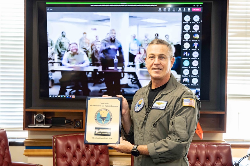Rear Adm. Pete Garvin, commander, Naval Education and Training Command (NETC), presents Mr. Damon Deloach, a product line analyst for NETC’s Supply Chain Operations (N31) in Millington, Tenn., with a plaque for his selection as NETC’s fiscal year 2022 senior civilian of the year during an awards ceremony in Pensacola, Fla., Jan. 10, 2022. NETC’s mission is to recruit, train and deliver those who serve our nation, taking them from street-to-fleet by transforming civilians into highly skilled, operational and combat ready warfighters. (U.S. Navy photo by Mass Communication Specialist 2nd Class Zachary Melvin)